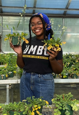 Lauren in greenhouse with radish, 2021